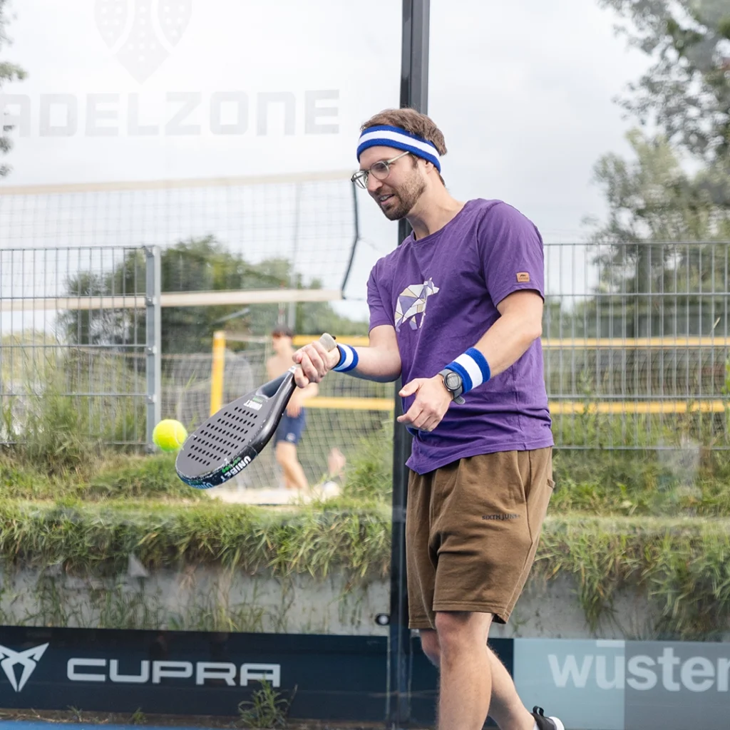 Captain Athletic Club member serving the ball on the Padel court during a Founders Club networking event, showcasing the action and energy of the game.